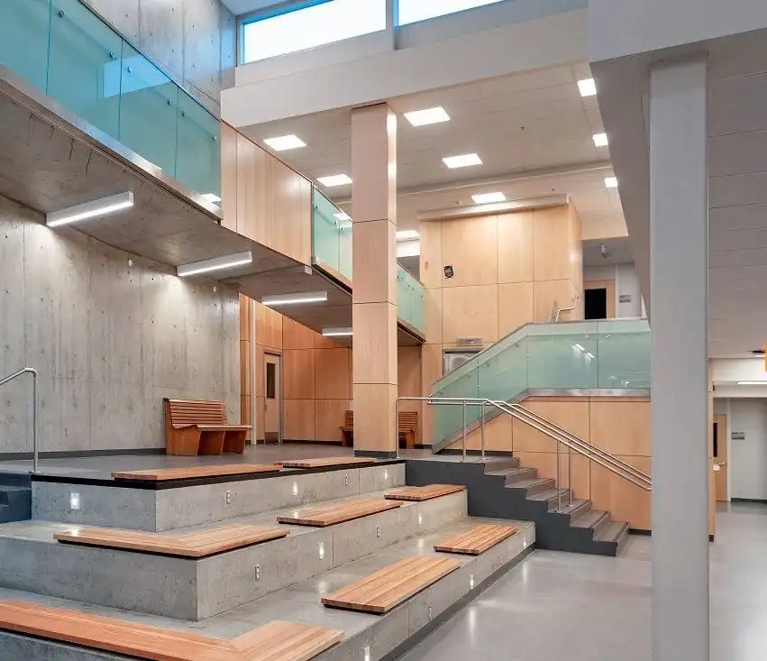 Common area with wood wall panelling and built-in seating